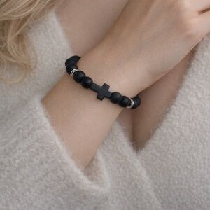 This elegant bracelet features smooth matte black beads paired with a bold black